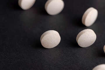 White and yellow medical medicines on a black background