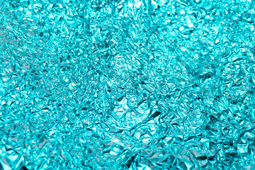 background crumpled metal foil texture. Metal glossy surface background. Futuristic backdrop for graphic design. Tin foil glitter. Reflective metal pattern