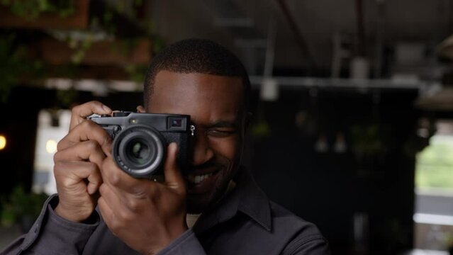 Young Black Photographer Taking A Picture With Vintage Camera 