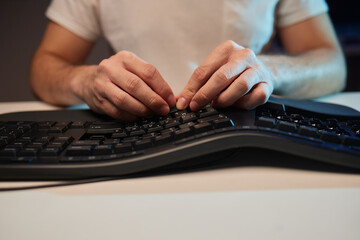 Old dirty computer keyboard with removed keys. The tools for repair and cleaning on the table in...