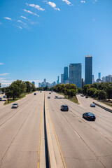 Highway driving into downtown Chicago on sunny blue sky summer day with skyline in background