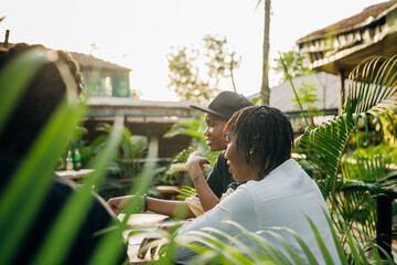 Two queer masculine black women in a garden