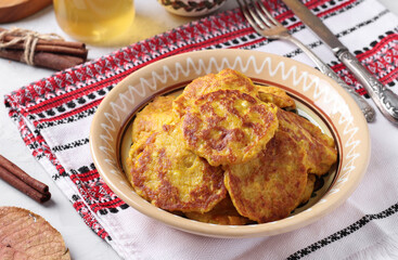Homemade pumpkin pancakes with curd, served for breakfast with sour cream and honey