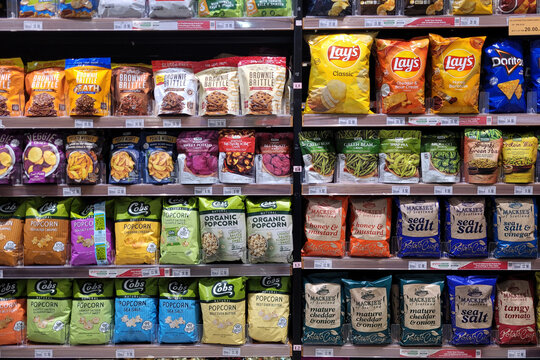 PENANG, MALAYSIA - 22 FEB 2023: Various local and imported brands of flavoured chips and snacks on store shelf in Jaya Grocer store. Jaya Grocer is the coolest fresh premium supermarket in Malaysia.