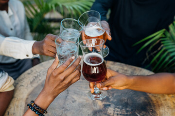 Queer masculine women having a beer in a garden