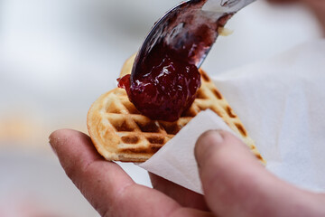 Preparing waffle or waffles with jam, dish made from leavened butter or dough that is cooked between two plates that are patterned to give a characteristic size, shape, and surface impression