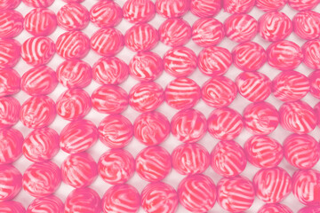 Red round tasty gummy candies as a background.