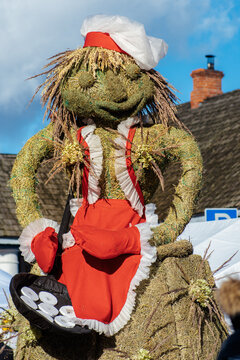 Traditional puppet made of straw preparing pancakes in Lithuania during Uzgavenes, a Lithuanian folk festival during Carnival, seventh week before Easter, vertical