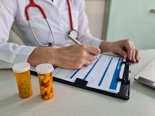 Health insurance payment form and pills on medical table