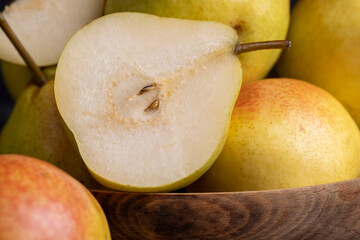 A yellow ripe pear with a red side on the table