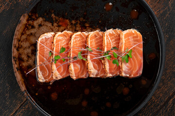 Fillet of fresh smoked salmon sliced on a plate with soy sauce. Asian dish sashimi from raw salmon, close up