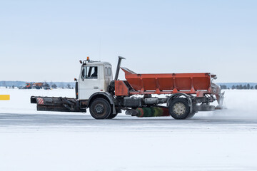 Snowblower cleans main taxiway at the airport in a snowstorm