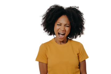 Young beautiful African woman with curly hair wearing casual yellow tshirt shouting with anger