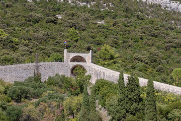 Fototapeta na wymiar The City Wall above Ston village, seen from the village