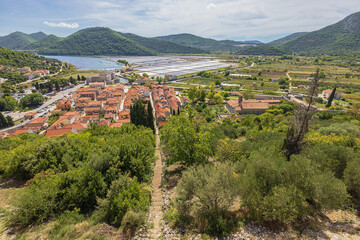 A disused stairs leading to the center of Ston With the saltworks and the Adriatic Sea in the background