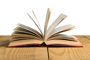 An open book lies on a wooden table