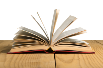 An open book lies on a wooden table