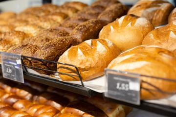 fresh golden breads on the shelf of the bread section of the supermarket