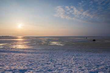 sunset over the frozen sea in winter. Kalajoki, Finland