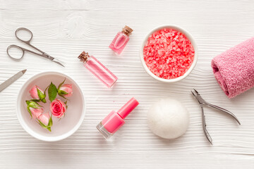 Fototapeta na wymiar Manicure set with roses water in bowl. Herbal hands care cosmetic set.