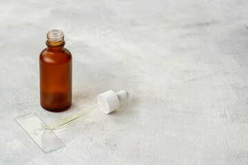 Essential serum oil in dropper bottle. Cosmetic products background