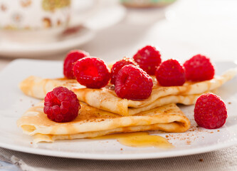 delicious pancakes with fresh raspberries and honey