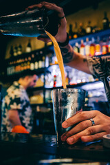 man hand bartender making cocktail in glass on the bar counter