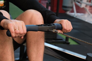  February 21, 2023 Ukraine, Dnipro. Rowing machine firm Concept 2. A man on a workout in the gym with his own weight. aeromagnetic simulator. Scandinavian traction for strength work of the back muscle © Mary_muis/stoker ua