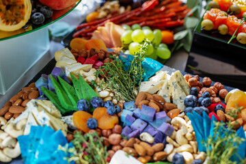 Cheese plate served with dried apricots, berry and nuts. Flat lay. Food concept