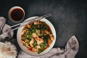 Top view,  Stir-fried pork and red hot curry paste with or long bean and Ingredients are oyster sauce, fish sauce, sugar, kaffir lime leaves in the dish Eat with cooked rice. Thai food