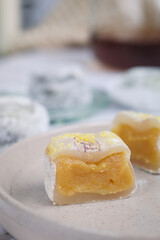 An authentic traditional Japanese mochi filled with yuzu citrus flavored  in a plate cut in two pieces. It is a Japanese rice cake made of mochigome, a short-grain japonica glutinous rice