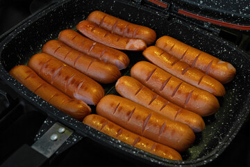 Juicy sausages cooked in a non-stick pot.