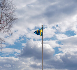 Swedish flag flying on the blue sky