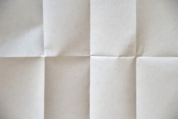 A clean white sheet of paper, folded four times. Blank for you caption