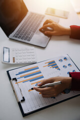 Entrepreneur Asian businessman and businesswoman discussing new business project in tablet in modern Meeting In Modern Office, Asian business casual concept.