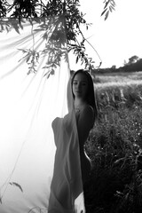 Beautiful girl in a wheat field. Black and white photo.
