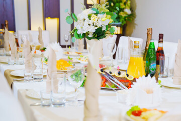 table served. empty glasses and a plate with a cloth napkin on the table. 