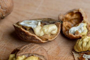 Open and broken walnut shells lying on the table