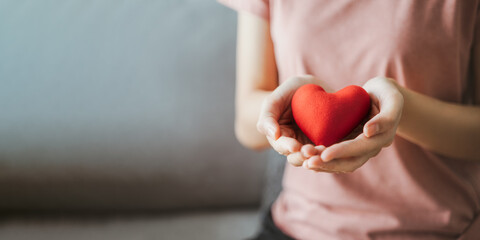 Woman holding red heart, love, health insurance, donation, happy charity volunteer, world mental health day, world heart day, valentine's day