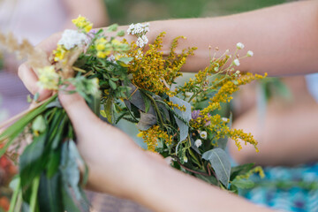 Making a Festive flower wreath,  circlet of flowers, festival coronet of flowers on a bright sunny...