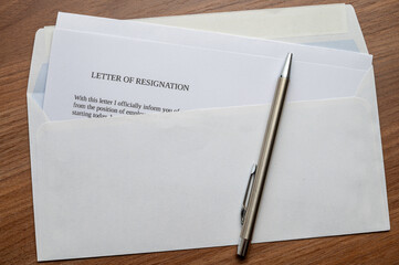 Employee resignation letter and pen beside. 

