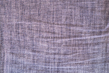 Crumpled blue and purple denim background, detailed fabric texture with high resolution.