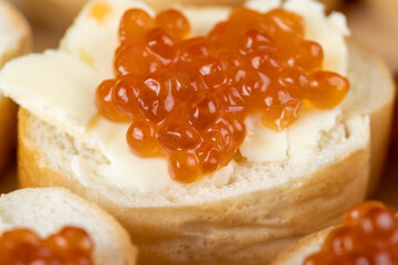 Thinly sliced baguette with salmon caviar and butter