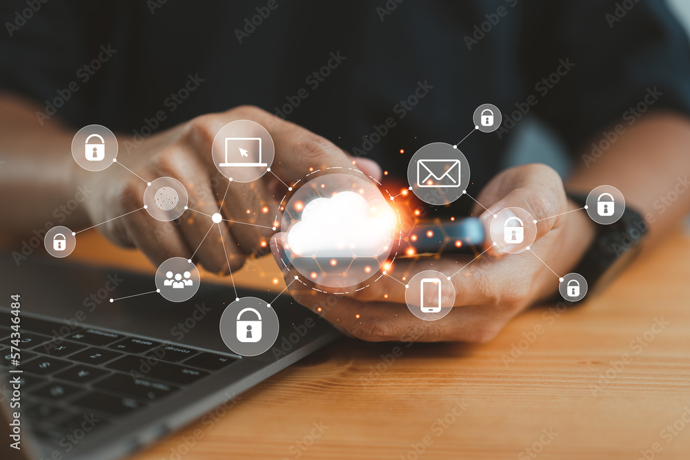 Aufkleber businessman in an office working on his smartphone and selecting the cloud icon on a virtual display. This symbolizes the use of digital technology and cloud technology.