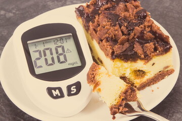 Glucometer for checking sugar level and fresh baked cheesecake. Diabetes and dieting during diabetes