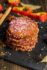 Sliced sausage with spices and lots of sesame seeds
