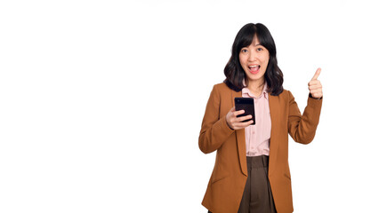 Surprised beautiful young Asian lady using mobile phone with positive expression, smiles broadly, dressed in casual clothing on white background. Happy adorable glad woman rejoices success