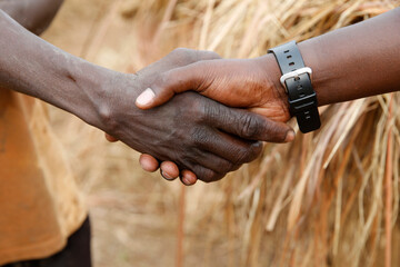 Shaking hands in  Uganda.