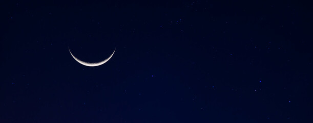 Obraz na płótnie Canvas Panorama dark blue sky.Photo of waxing cresent moon.Leap Year Last Quarter Moon.