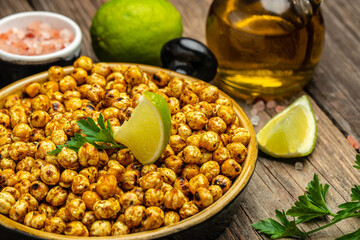 Fried roasted spicy chickpeas or Indian chana or chole with lime. Tasty vegetarian and vegan chickpea snack. banner, menu, recipe place for text, top view